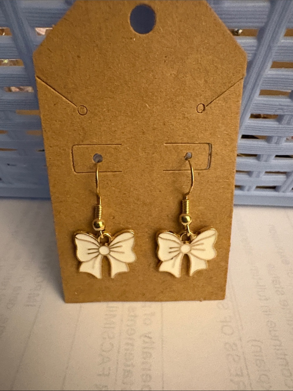 Delicate White Bow Drop Earrings with Gold Accents